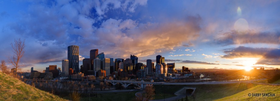 A panoramic view of the downtown Calgary skyline at sunset.
