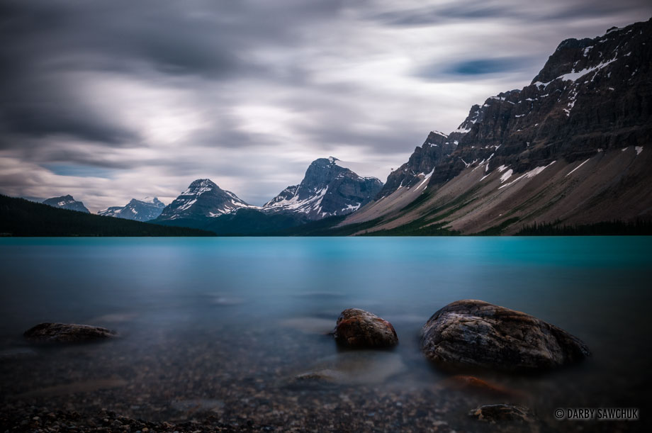 The calm, blue, glacial waters of Bow Lake in Banff National Park, Alberta, Canada.