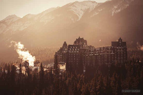 The Canadian Rockies tower over the Banff Springs Hotel in Banff, Alberta, Canada.