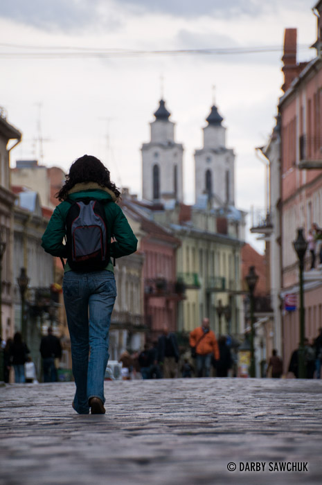 A backpacker walks along Vilniaus Gatve in Kaunas, Lithuania.