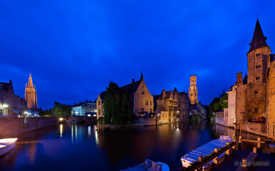 The river Dijver in Bruges, Belgium with the Church of Our Lady on the left and the Belfry on the right.