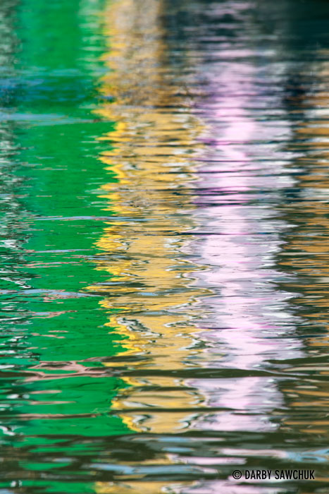 The colours of the houses of Burano dance in the reflections on the water of the canals.