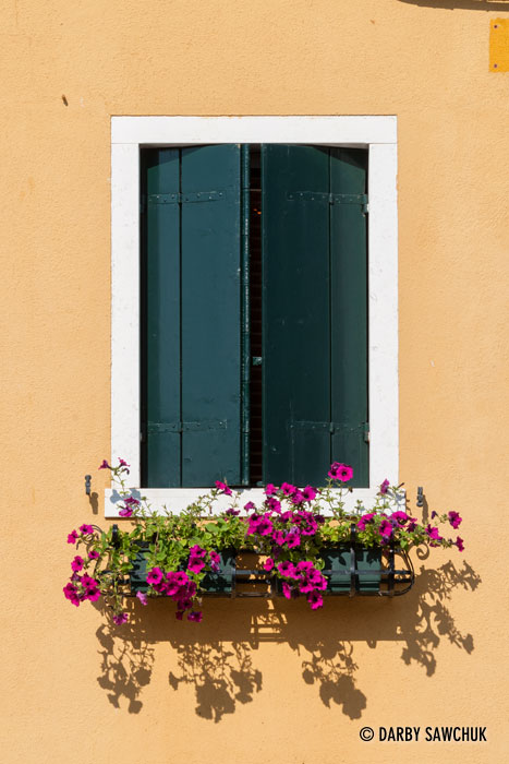 The window of a yeloow house in Burano, Italy.