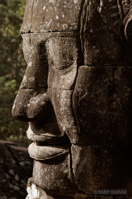 One of the massive, serene stone faces at the temple of Bayon in Cambodia.