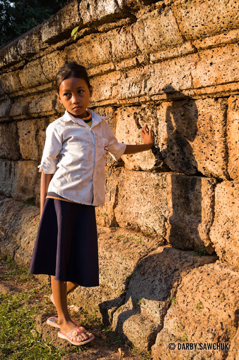 An elementary school student in a the schoolyard near the temple of Bakong in Cambodia.