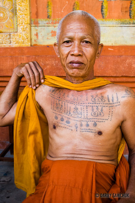 A Buddhist monk displays his tattoos at the Bakong Monastery in Cambodia.