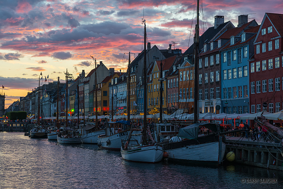 The colours of the sky mimic the colourful facades behind the boats moored in the Nyhavn Canal in Copenhagen, Denmark.