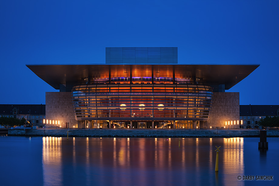 The Copenhagen Opera House on the waterfront at night.