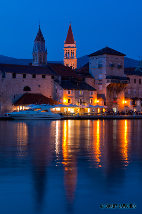 Trogir Cathedral's campanille peers above the buildings lining the boardwalk in Trogir, Croatia.