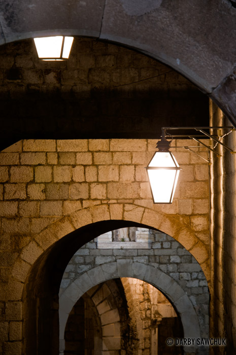 Lanterns illuminate archways in Dubrovnik, Croatia.