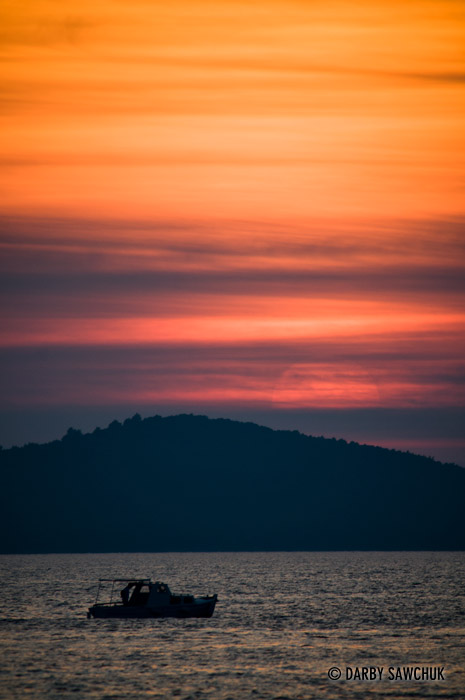 A boat passes in front of one of Zadar's always impressive sunsets.