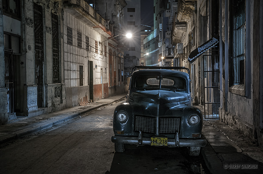 A vintage American car on the streets of Havana, Cuba at night.
