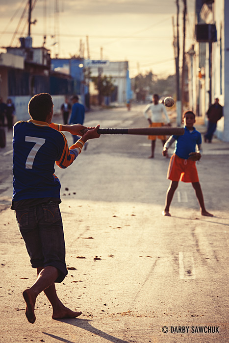 Children play baseball in the streets of Cienfuegos, Cuba.