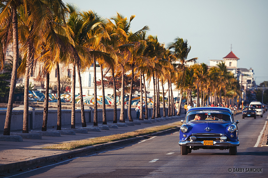 A vintage American car drives up Cienfuegos' version of Havana's Malecon: Paseo del Prado.