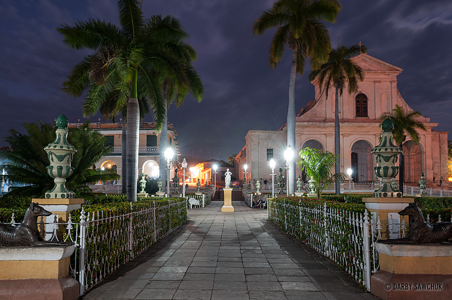 Museo Romantico on the left and the Santísima Trinidad Cathedral on the right at Plaza Mayor at the centre of Trinidad, Cuba at night.