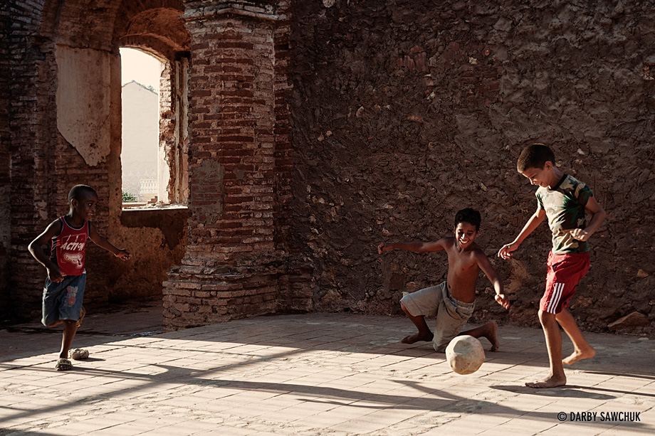 Boys play football in a ruined portion of the Iglesia de Santa Ana in Trinidad, Cuba.