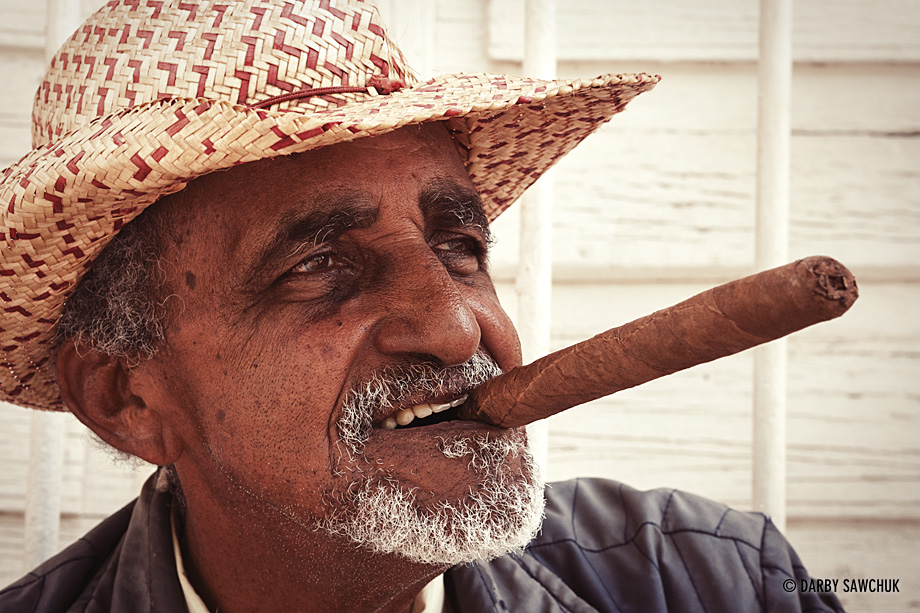 A Cuban man prepares to light a large Cuban cigar in Trinidad, Cuba.