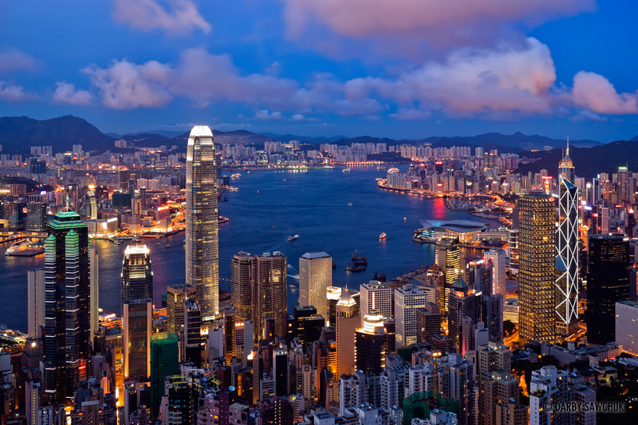 The skyscapers surrounding Hong Kong Harbour glow in the evening in a view from Victoria Peak.
