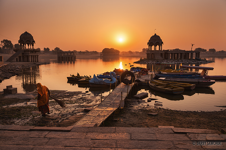 Temples and shrines cluster around Gadsisar Lake in Jaisalmer at sunrise.