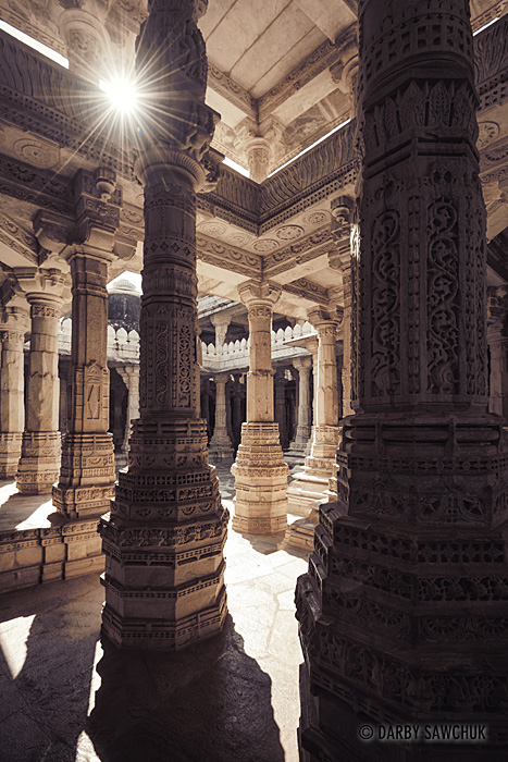 Sunlight peeks between the ornate columns inside the Jain temple in Ranakpur.
