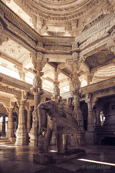 A marble elephant statue stands amid the unique pillars of Ranakpur's Jain temple.