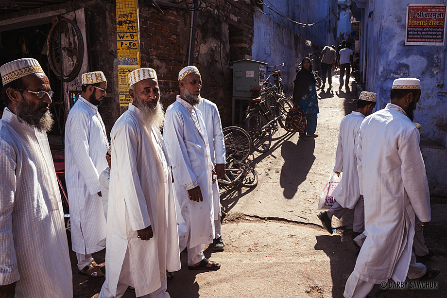 A group of men follow a procession towards a Muslim wedding in the streets of Bundi, India.