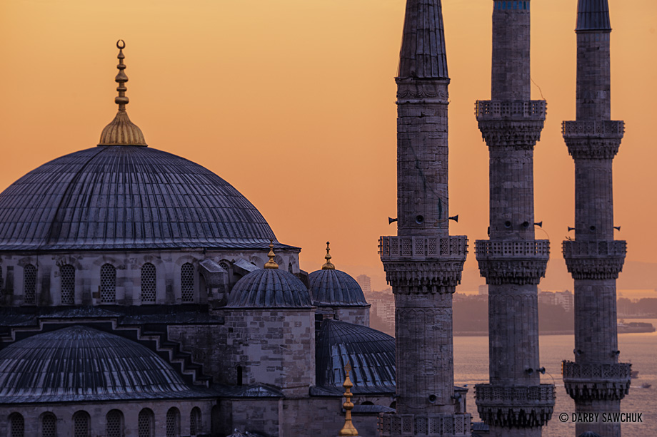 A close up view of the Blue Mosque's domes and minarets at sunset.