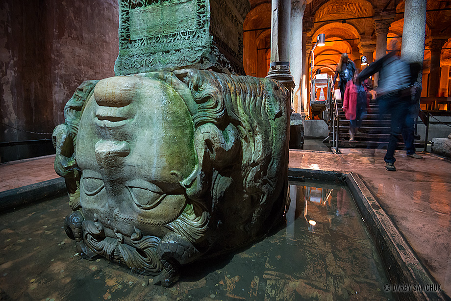 The upside down Medusa head supports one of the many columns inside the Bascilica Cistern beneath Istanbul, Turkey.