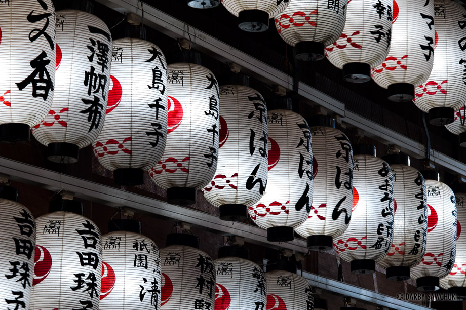 Traditional white Japanese paper lanterns hanging at the Yasaka Shrine in the Gion district of Kyoto, Japan.