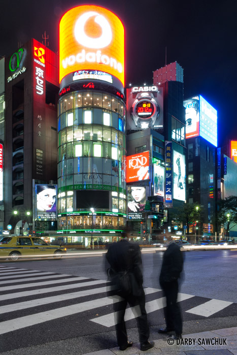 The bright lights of the Ginza shopping district in Tokyo, Japan at night.