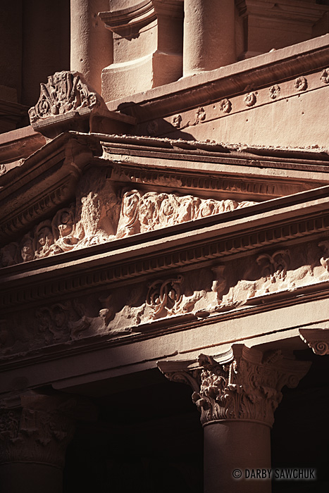 A detail view of the morning light striking the facade of the Treasury in Petra, Jordan.