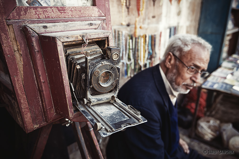A vendor sits with a vintage camera at an open air market in Amman, Jordan.