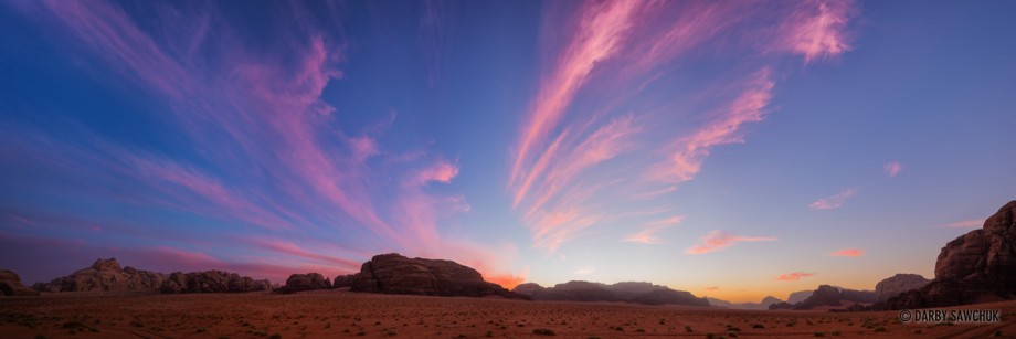 A panoramic view of the colourful sunset over the desert of Wadi Rum.