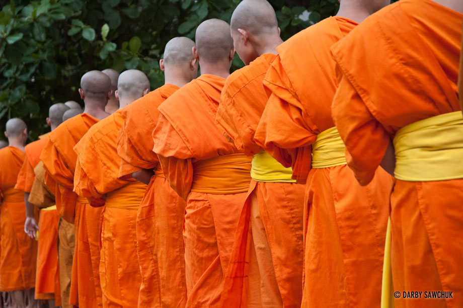 Hundreds of novice monks walk the streets early in the morning during the alms ceremony in Luang Prabang, Laos.