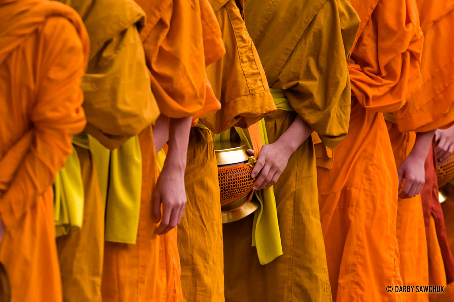 Hundreds of novice monks walk the streets early in the morning during the alms ceremony in Luang Prabang, Laos.