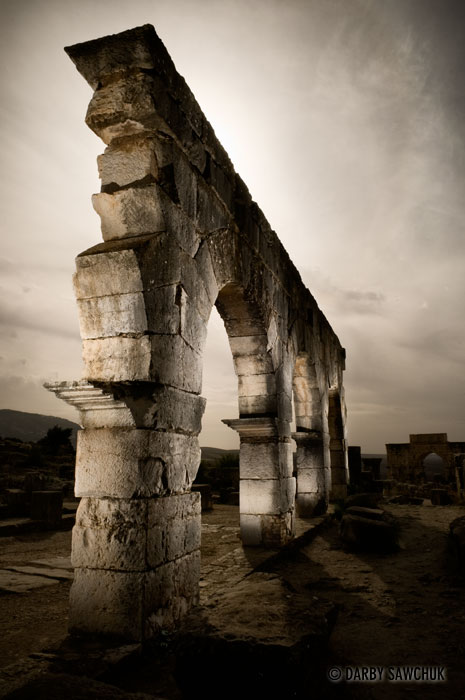 A ruined archway at the Roman ruins at Volubilis, Morocco.