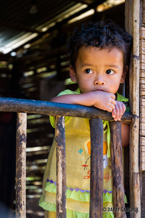 A young Orang Asli Child looks out from a hut in the Cameron Highlands in Malaysia.