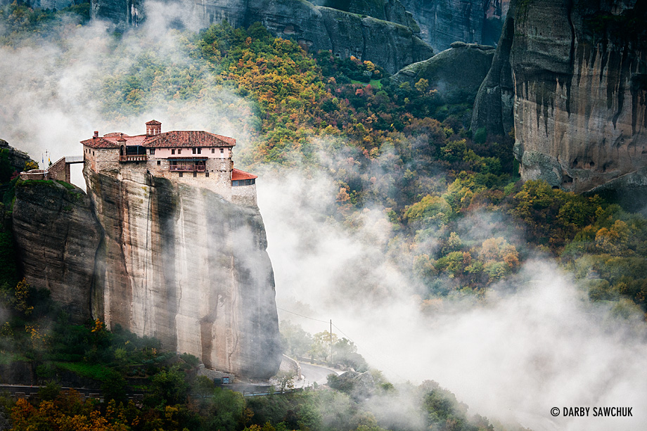 Clouds roll past the cliff-top Monastery of Rousanou in Meteora, Greece.