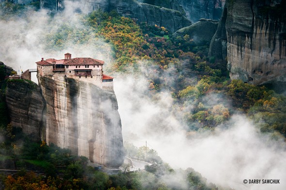 Clouds roll past the cliff-top Monastery of Roussanou in Meteora, Greece.