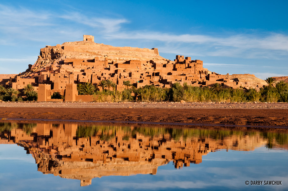 The fortified city of Ait Benhaddou reflected in the neaby river, a ksar between Marrakech and the Sahara desert in Morocco.
