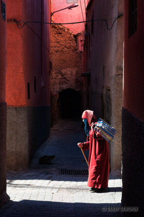 A woman walks in an alley in Marrakech.