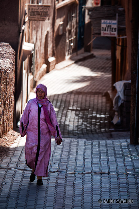 A woman walks in an alleyway in Ouarzazate, Morocco.