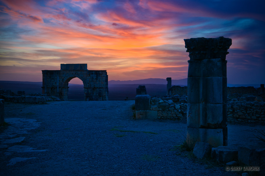 The main road of Volubilis leading to the Triumphal Arch at sunset.