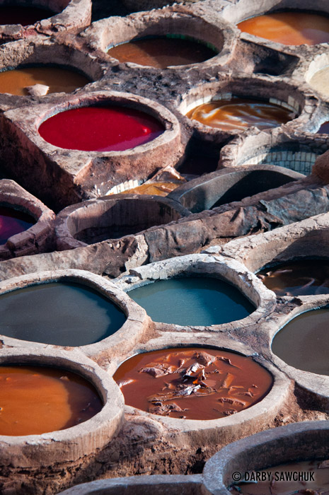 Leather rests in vats filled with colourful dyes at the oldest leather tanneries in the world in Fes, Morocco.