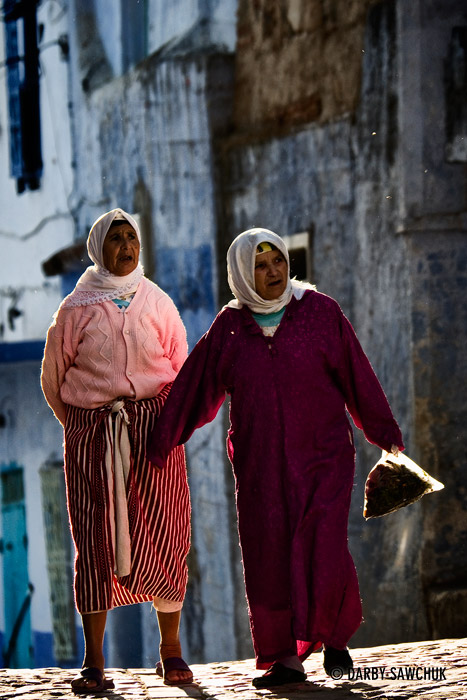 Women return from shopping in Chefchaouen, Morocco.