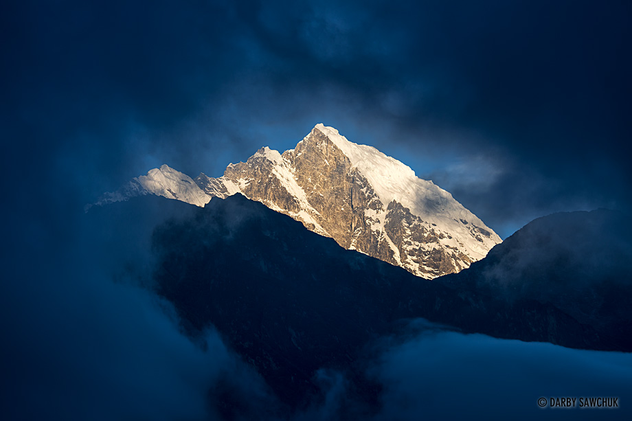 Clouds part to reveal one of the mountains near Lukla, Nepal.