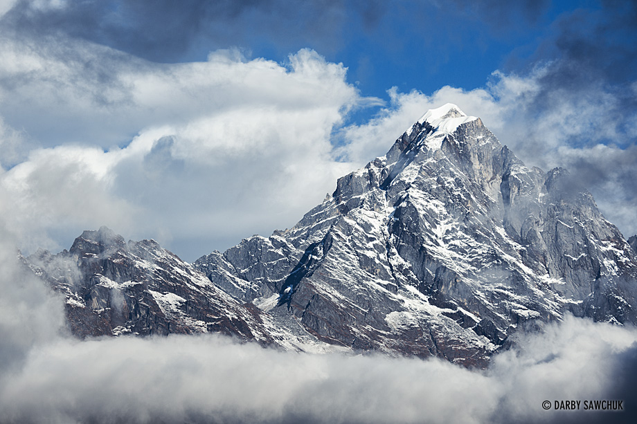 Clouds part to reveal one of the mountains near Lukla, Nepal.