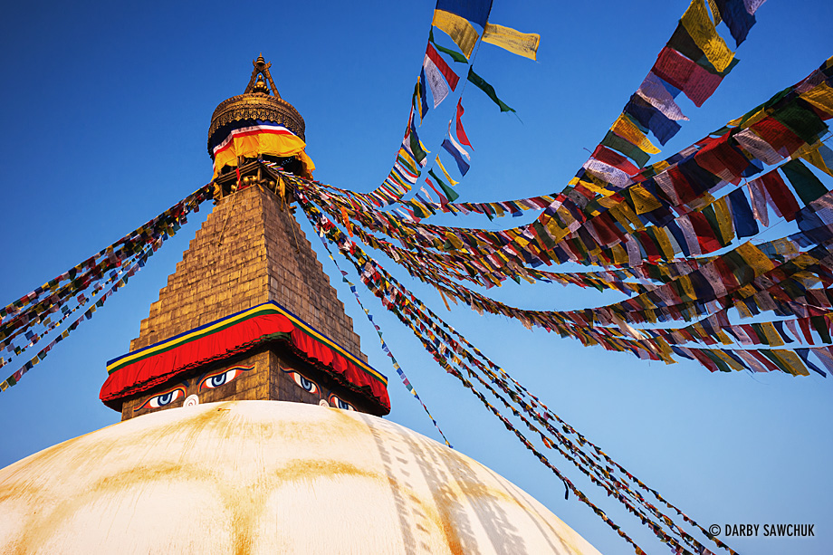 Prayer flags hang from the Buddhist Boudha Stupa, one of the world's largest stupas, in Kathmandu, Nepal.