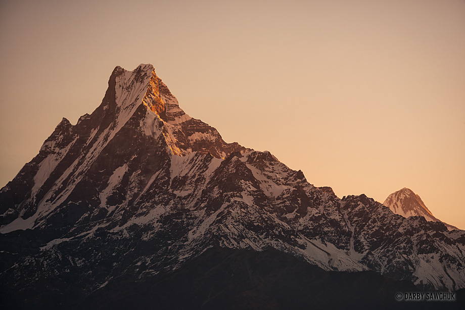The first light of day hits Mount Machhapuchchhre also known as Mount Fishtail for its distinctive shape.