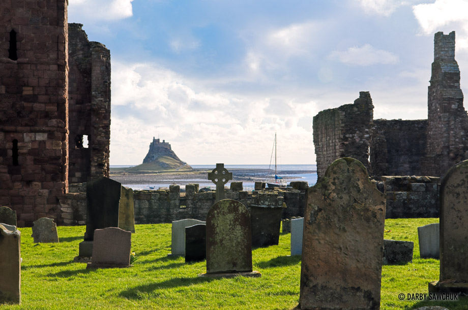 The cemetery on Lindisfarne Island with Lindisfarne Castle in the background.